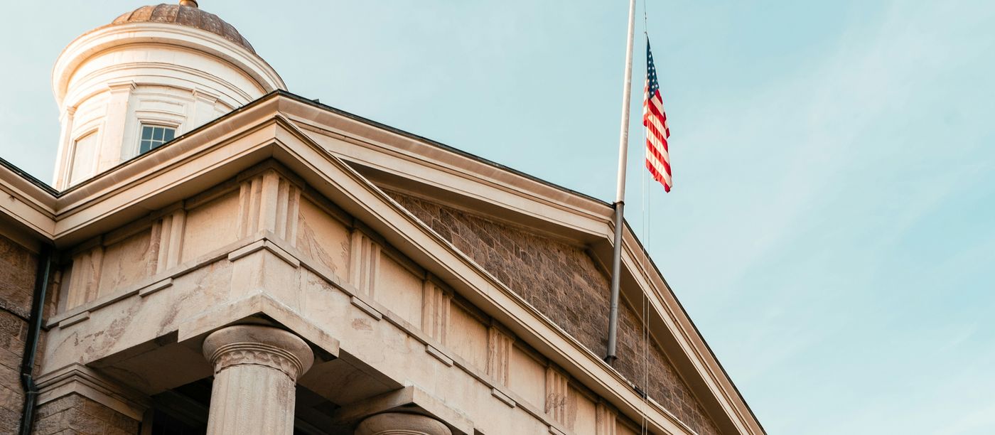 Government building with stone columns and an American flag